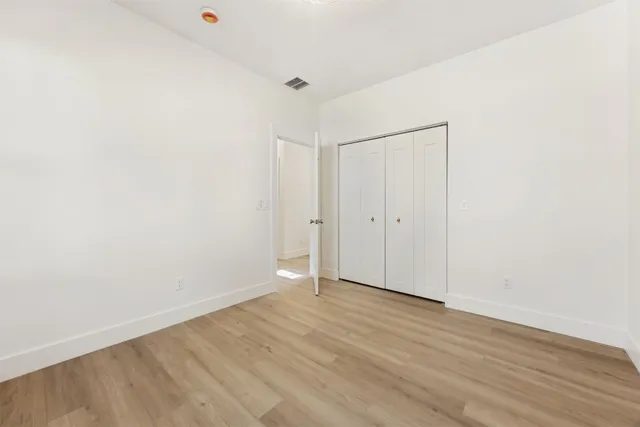 a room with water heater and wooden floor