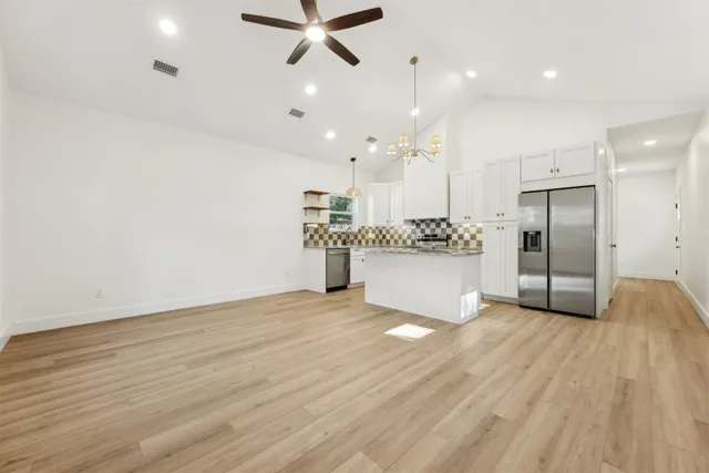 a view of a kitchen with a sink and a refrigerator