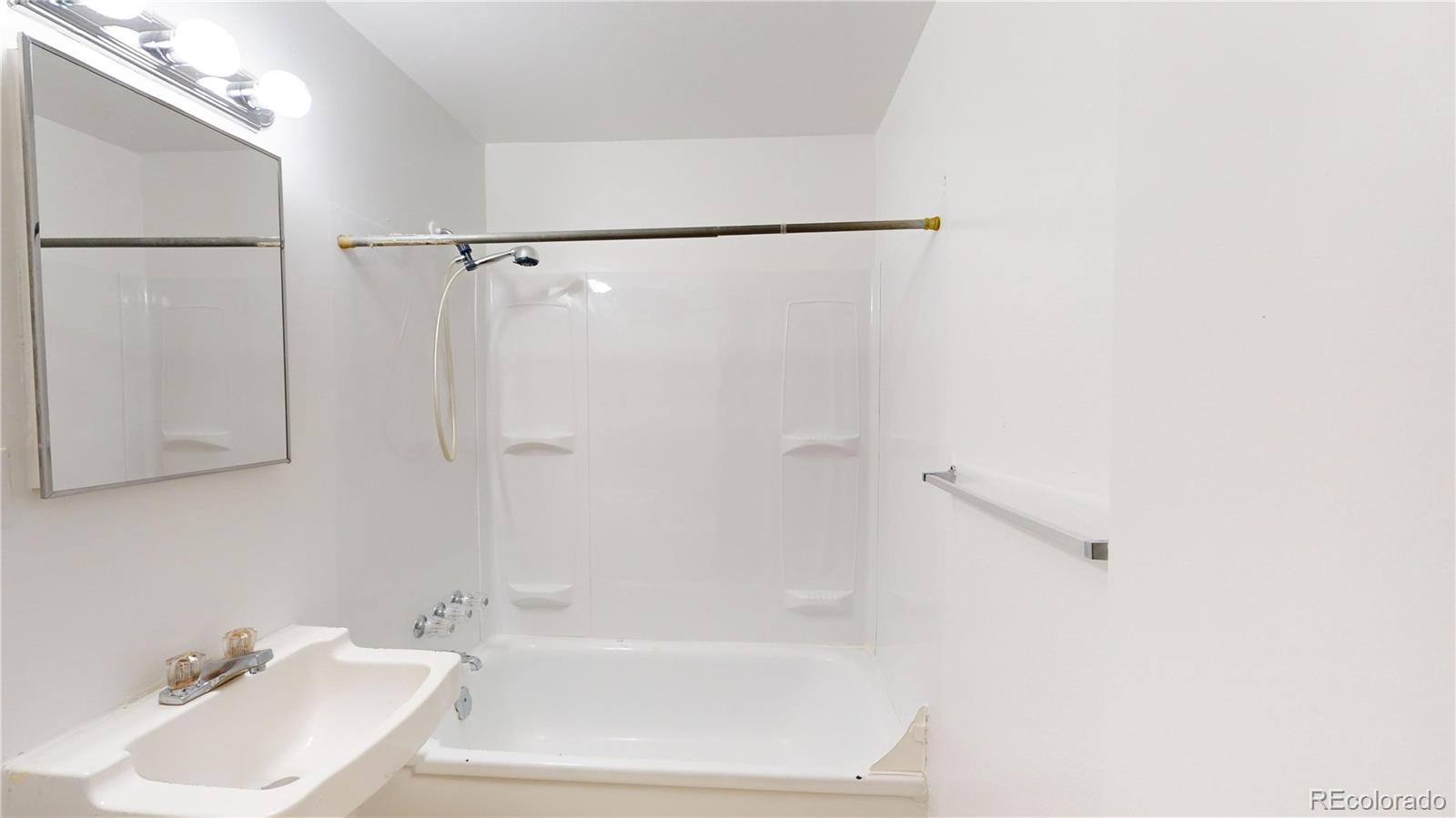 1251 Upham Street, Unit 8 Lakewood, CO 80214 - Photo 13 of 38 a bathroom with a sink and a shower