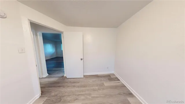 an empty room with an entryway door