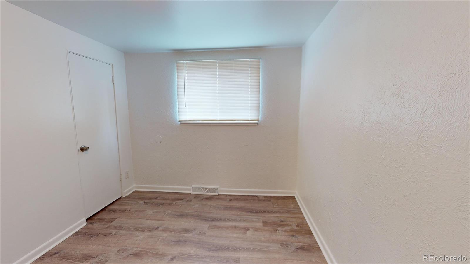 1251 Upham Street, Unit 8 Lakewood, CO 80214 - Photo 30 of 38 a view of a small space with wooden floor and a window