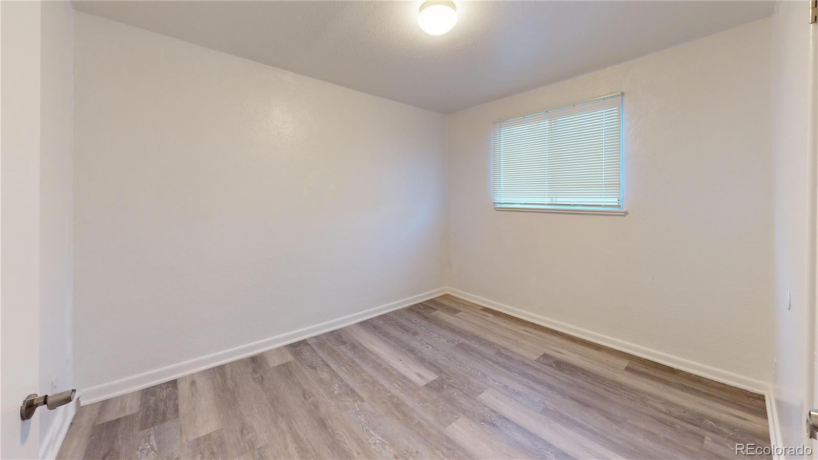 1251 Upham Street, Unit 8 Lakewood, CO 80214 - Photo 3 of 38 wooden floor in an empty room
