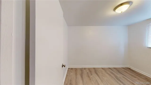 a view of room with window and hardwood floor