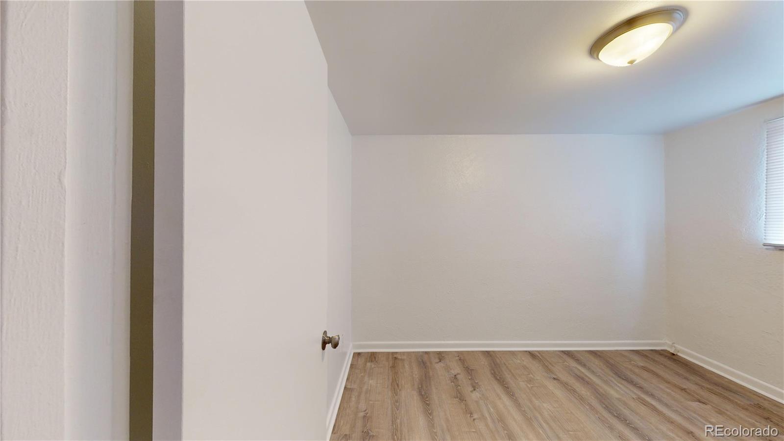 1251 Upham Street, Unit 8 Lakewood, CO 80214 - Photo 33 of 38 a view of room with window and hardwood floor