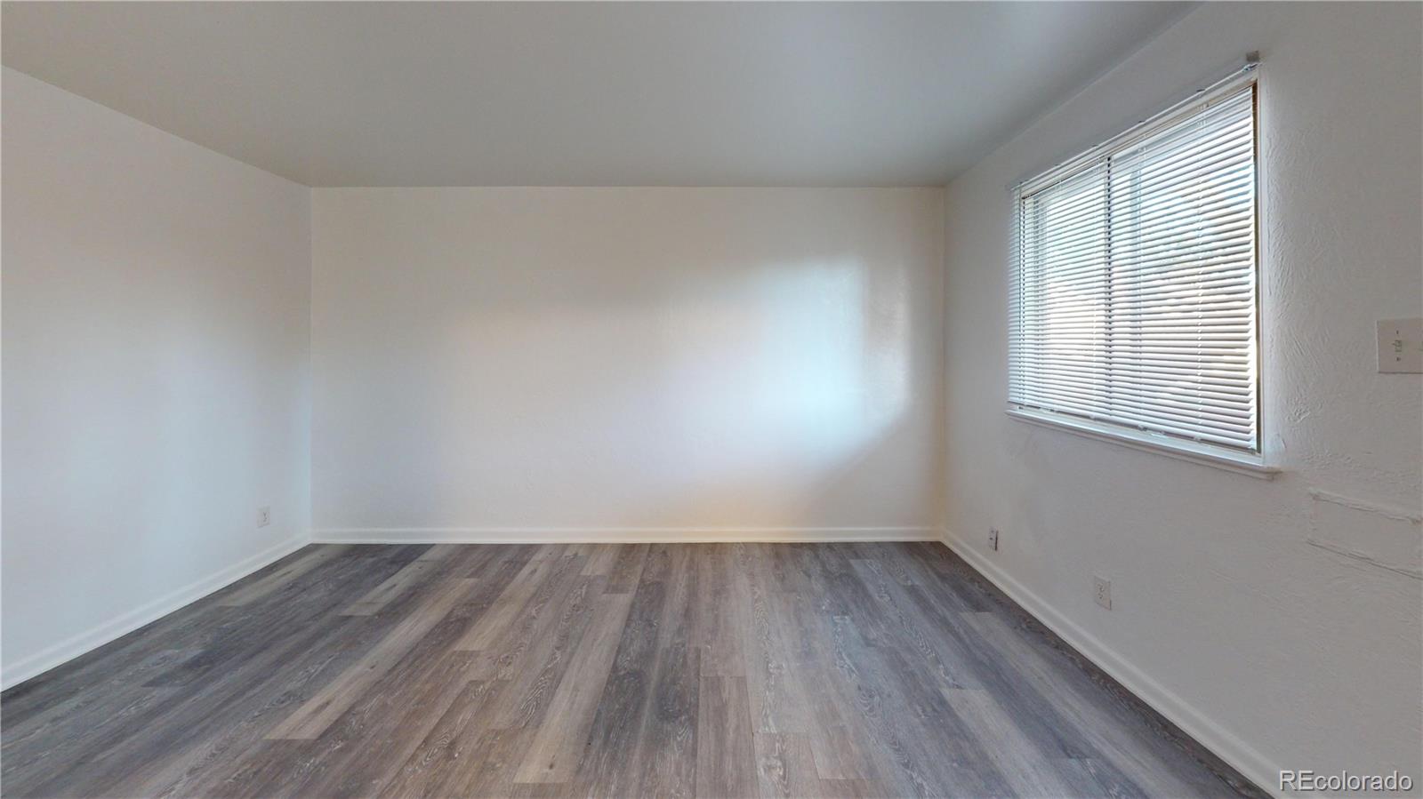 1251 Upham Street, Unit 8 Lakewood, CO 80214 - Photo 5 of 38 wooden floor in an empty room with a window