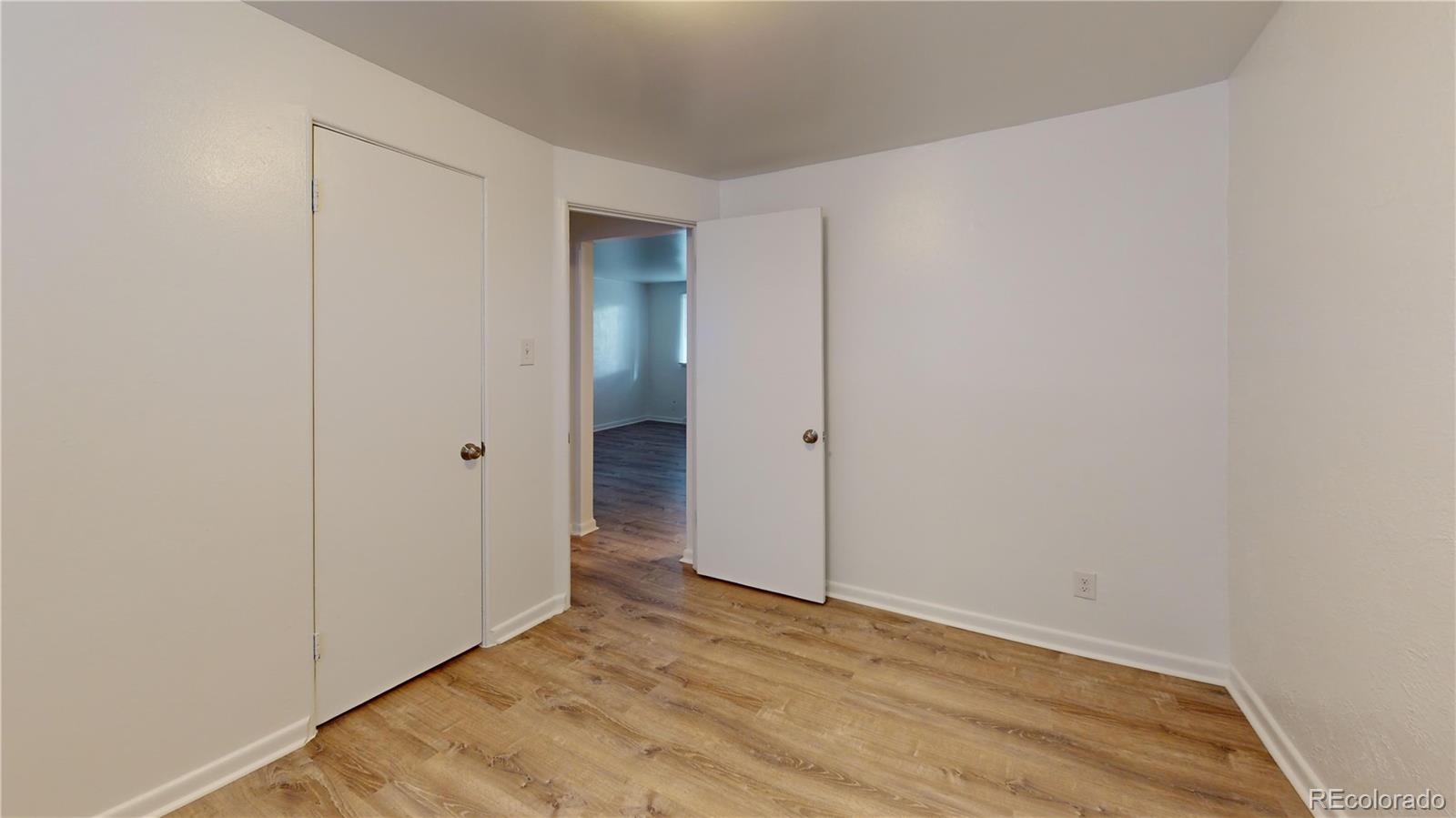 1251 Upham Street, Unit 8 Lakewood, CO 80214 - Photo 6 of 38 a view of an empty room with wooden floor