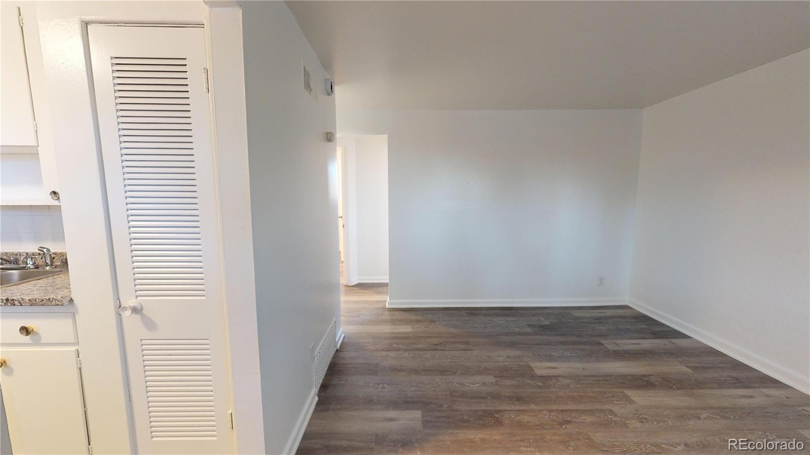 1251 Upham Street, Unit 8 Lakewood, CO 80214 - Photo 9 of 38 a view of a room with wooden floor and a window