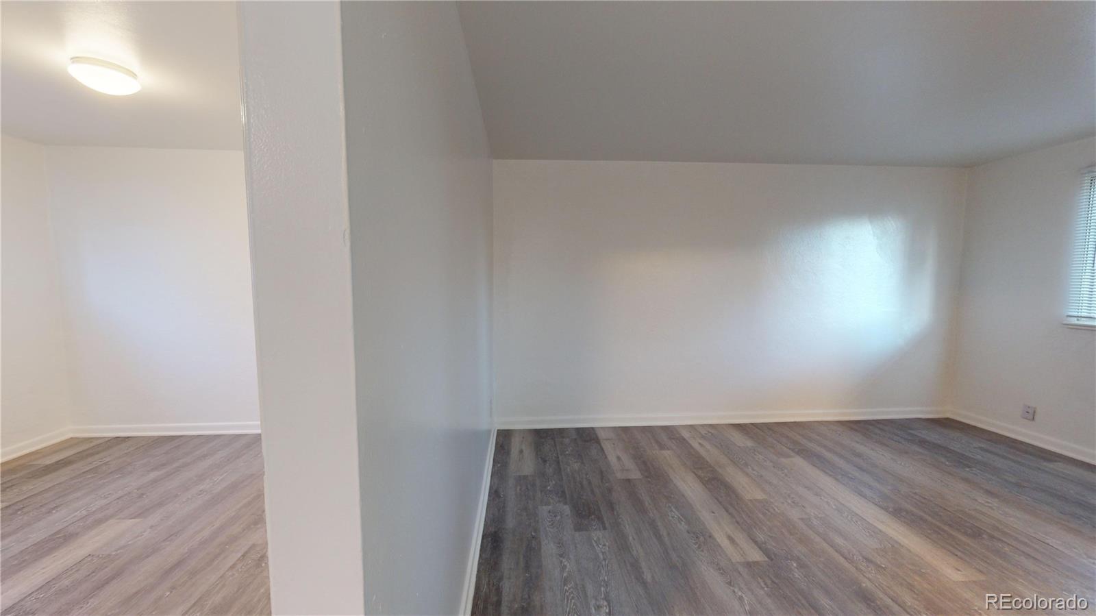 1251 Upham Street, Unit 8 Lakewood, CO 80214 - Photo 10 of 38 a view of an empty room with wooden floor
