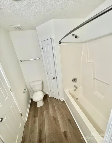 a bathroom with a bathtub and a toilet