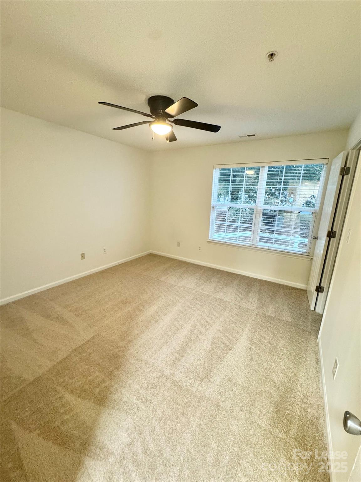 315 Flint Hill Road, Unit 202 Fort Mill, SC 29715 - Photo 14 of 14 an empty room with windows