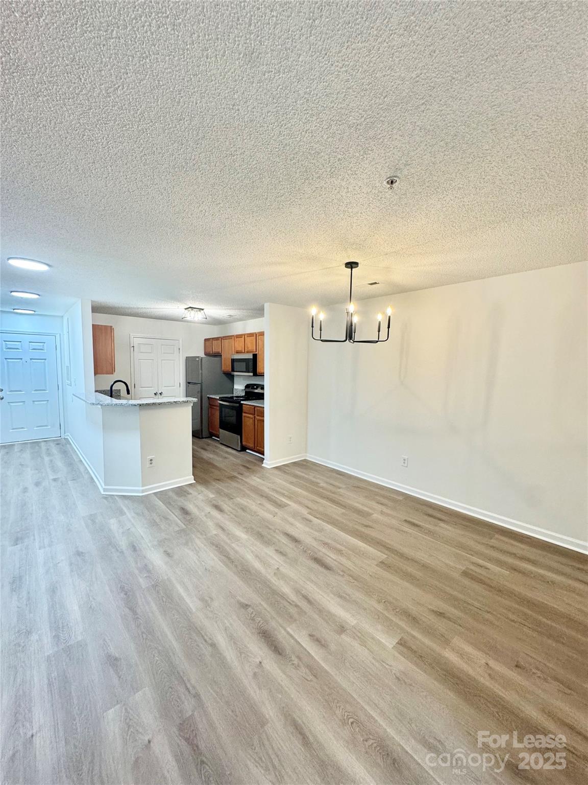 315 Flint Hill Road, Unit 202 Fort Mill, SC 29715 - Photo 4 of 14 a view of empty room with wooden floor