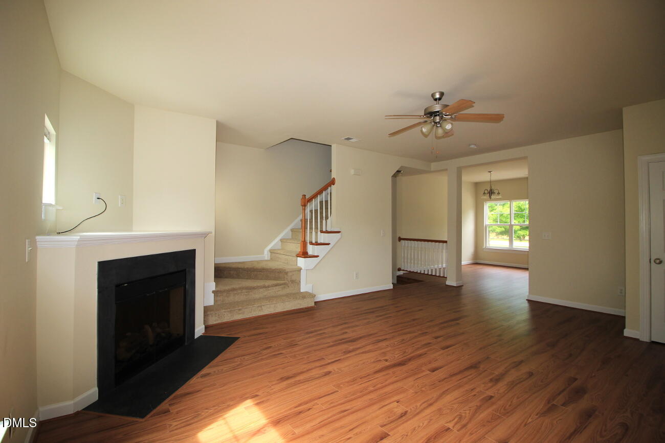 3705 Glenhaven Road Raleigh, NC 27606 - Photo 3 of 21 a view of empty room with wooden floor and fireplace
