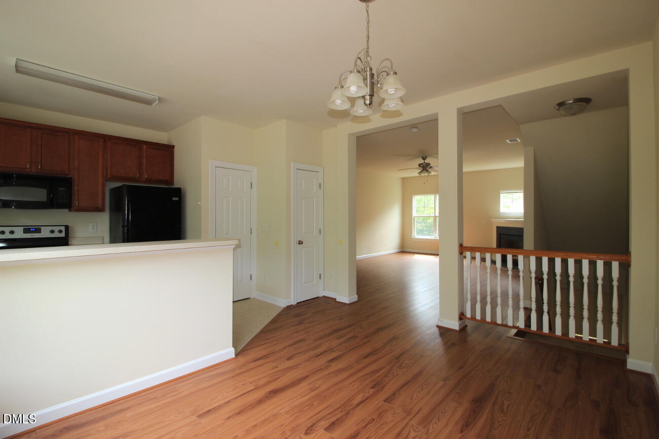 3705 Glenhaven Road Raleigh, NC 27606 - Photo 5 of 21 a view of a livingroom with wooden floor and staircase