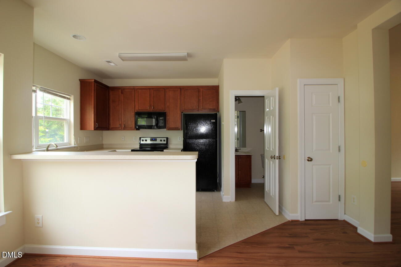 3705 Glenhaven Road Raleigh, NC 27606 - Photo 7 of 21 a kitchen with stainless steel appliances granite countertop a refrigerator a stove top oven a sink and dishwasher