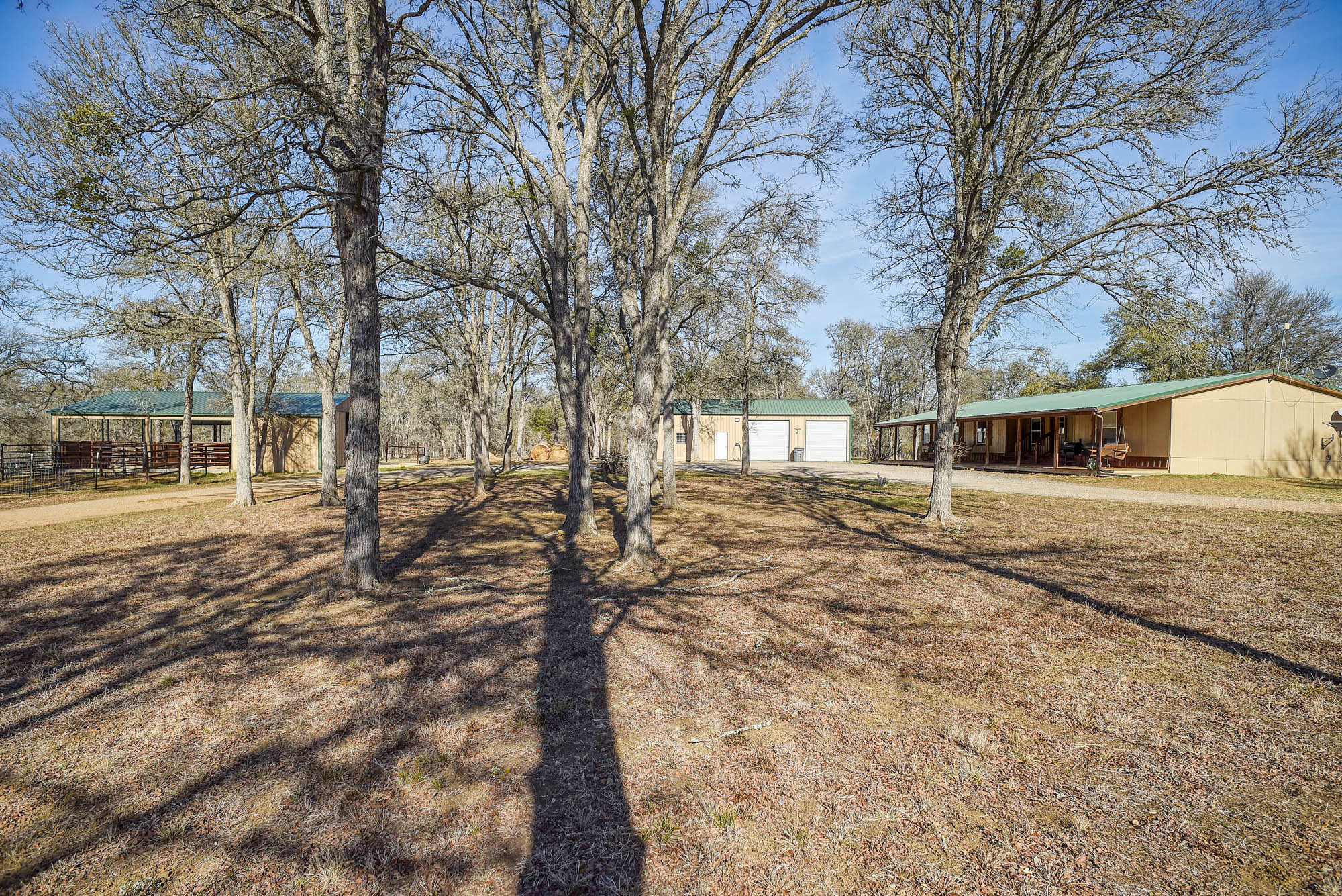 1675 Watterson Road Red Rock, TX 78662 - Photo 2 of 35 View of yard with an outbuilding, a detached garage, and driveway