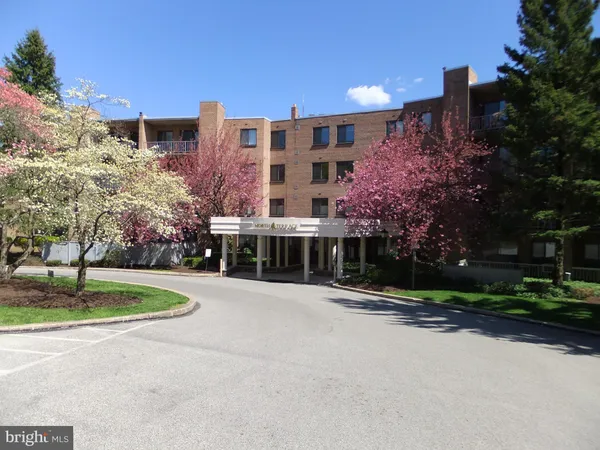 a front view of residential building with trees