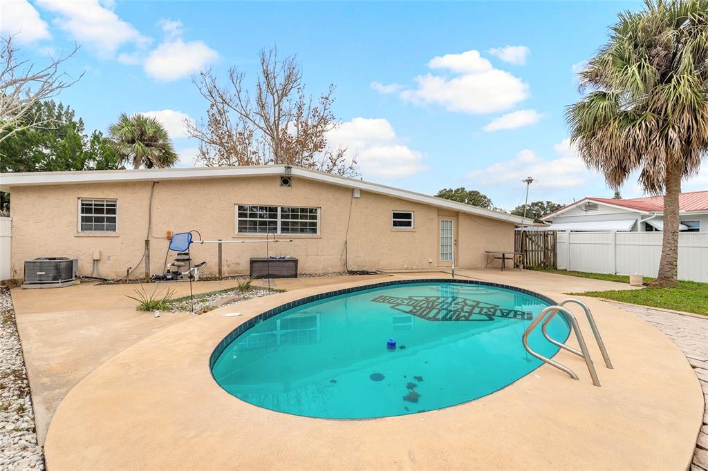 223 Charles Street Port Orange, FL 32129 - Photo 16 of 20 a view of backyard with swimming pool