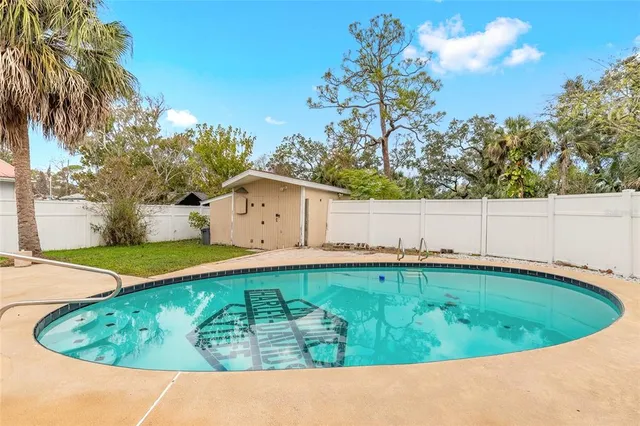 a view of a swimming pool with a yard