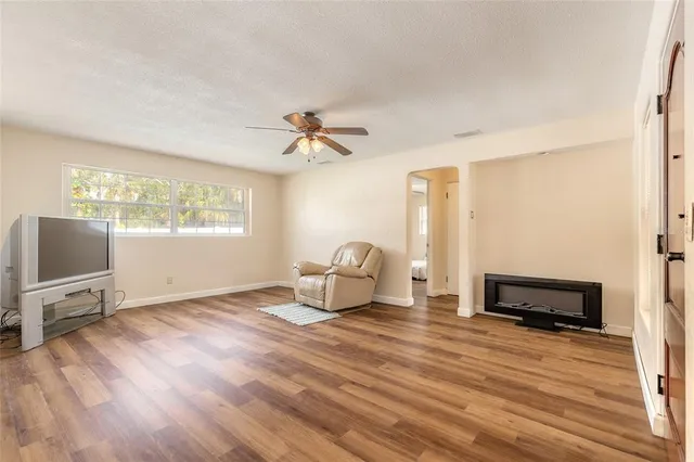 a living room with furniture a window and a flat screen tv