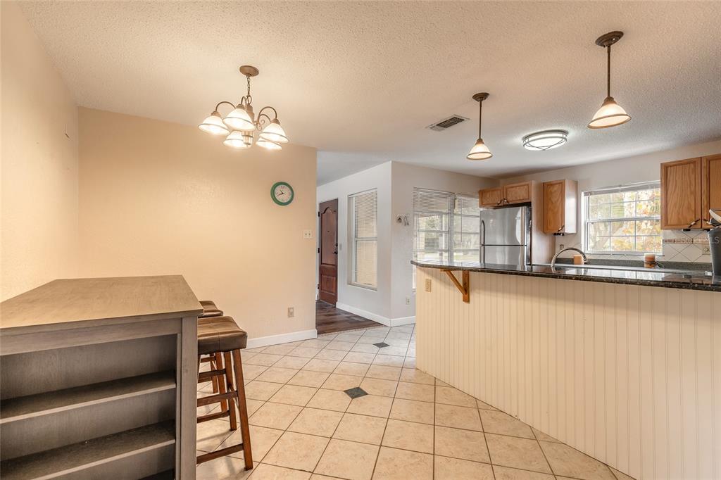 223 Charles Street Port Orange, FL 32129 - Photo 8 of 20 a view of kitchen with granite countertop cabinets and window