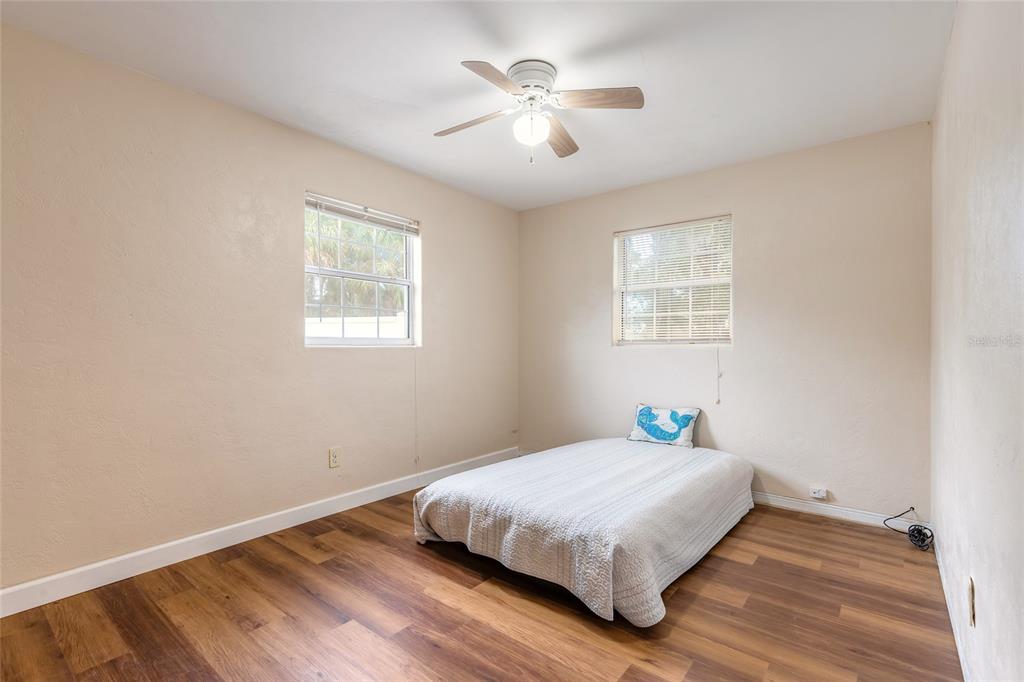 223 Charles Street Port Orange, FL 32129 - Photo 10 of 20 a bedroom with a bed and a chandelier