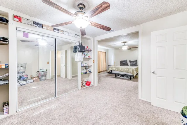 a view of a livingroom with furniture and a ceiling fan