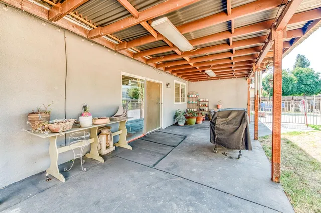 a view of a patio with table and chairs and potted plants