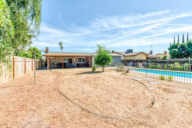 a view of a house with a yard and sitting area