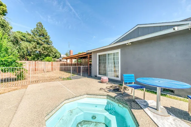 a view of a backyard with furniture and a patio