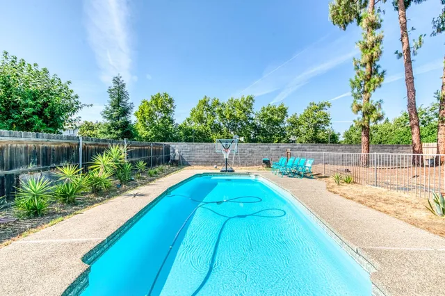 a view of swimming pool with a yard