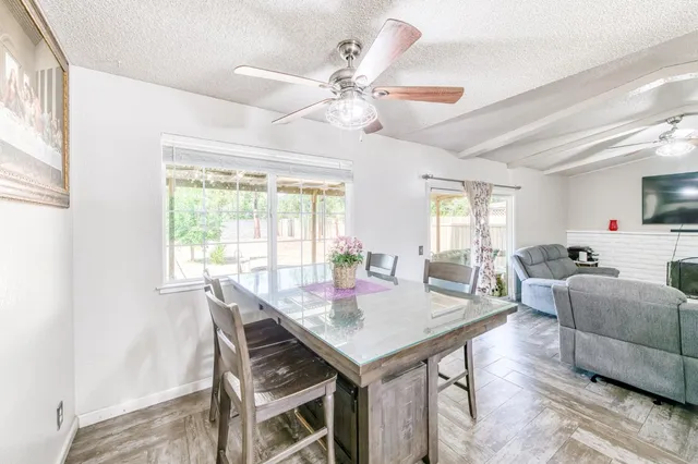 a view of a dining room with furniture and a chandelier
