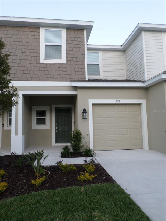 2118 Hallier Cove Wesley Chapel, FL 33543 - Photo 1 of 1 a front view of a house with a yard and garage