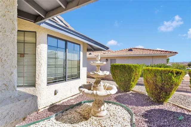 a view of a big room with windows and chandelier