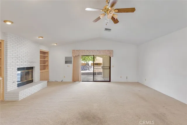 a view of a kitchen with a sink and a fireplace