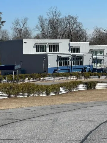 a front view of a house with swimming pool and a yard