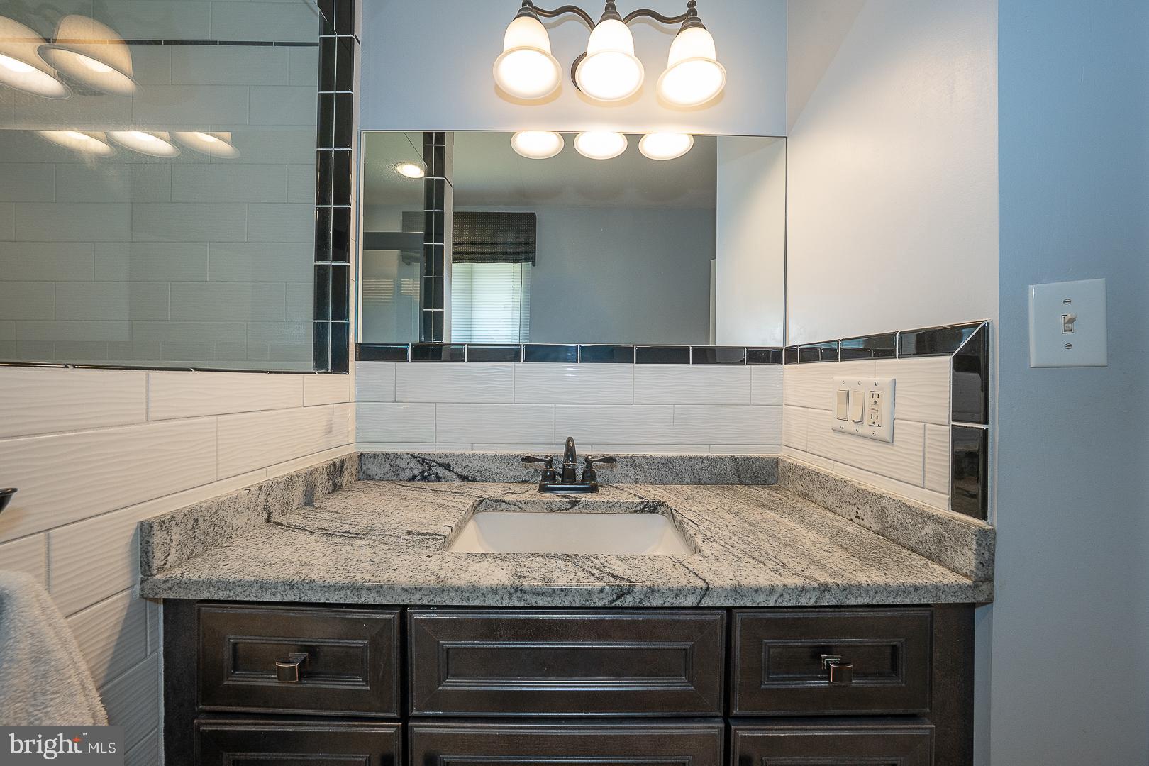 848 Mourning Dove Road Audubon, PA 19403 - Photo 30 of 86 a bathroom with a granite countertop sink and a mirror