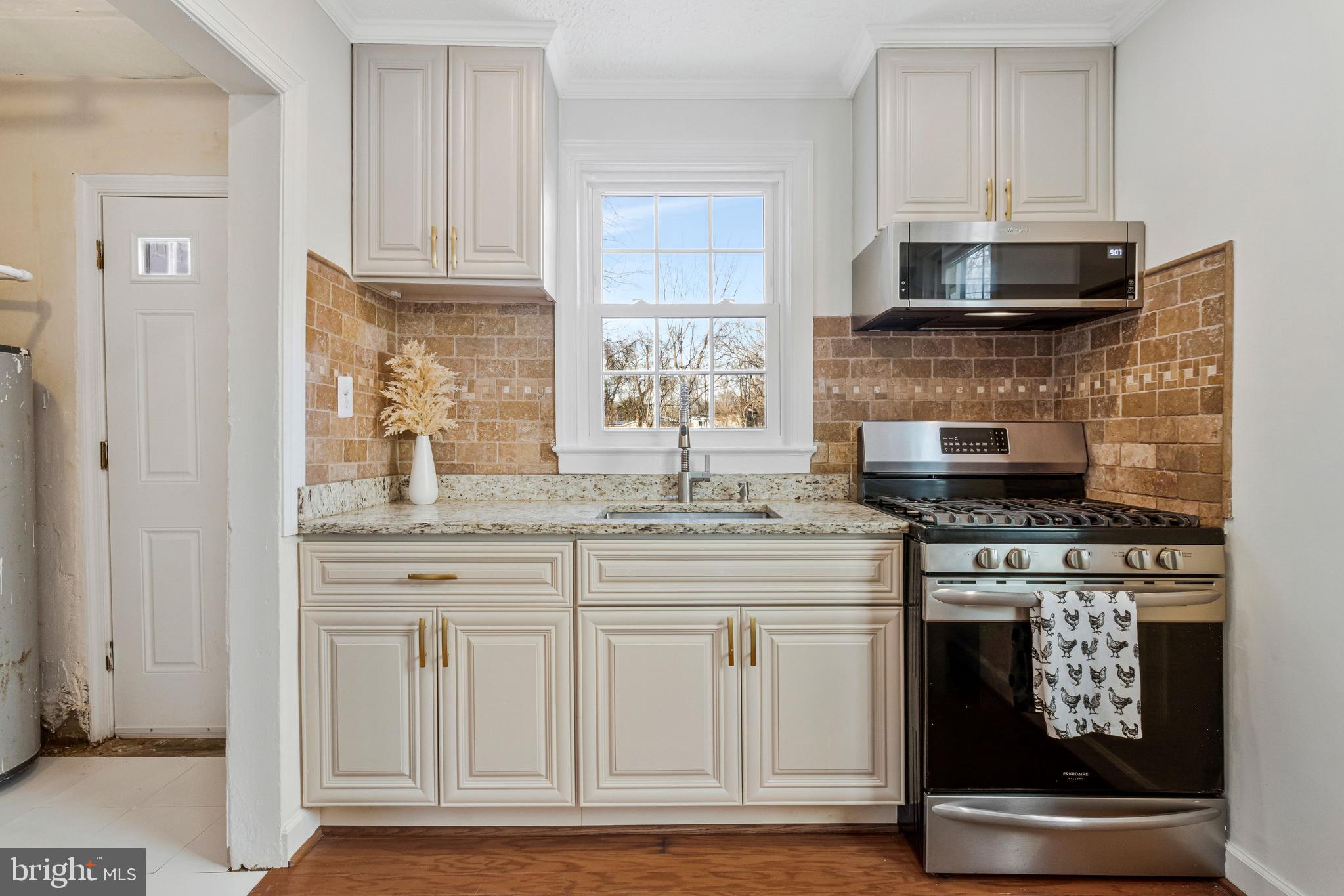 4332 Polk Street Northeast Washington, DC 20019 - Photo 7 of 22 a kitchen with stainless steel appliances granite countertop a stove and a microwave