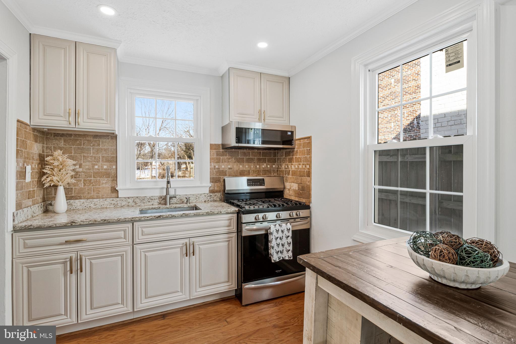 4332 Polk Street Northeast Washington, DC 20019 - Photo 8 of 22 a kitchen with granite countertop a stove and a sink