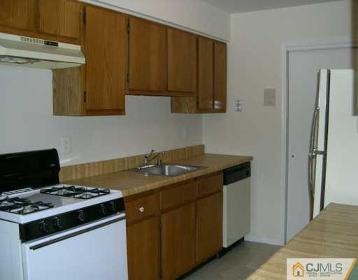 1526 Raspberry Court Edison, NJ 08817 - Photo 3 of 7 a kitchen with a stove and a microwave