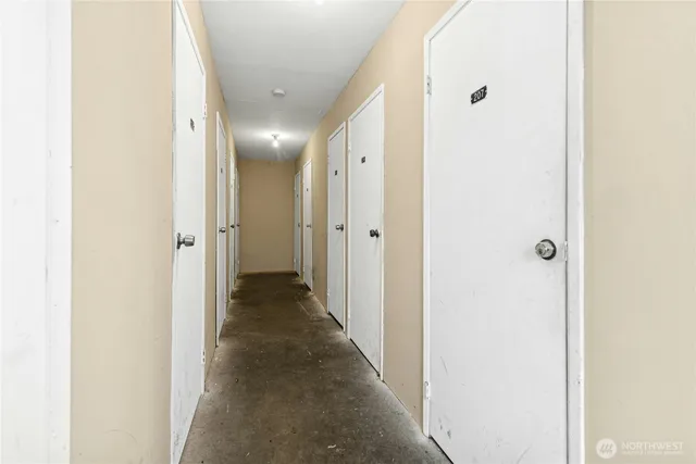 a view of a hallway with wooden floor