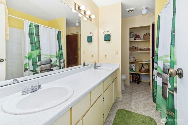 a bathroom with a double vanity sink and a mirror