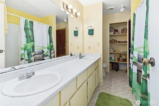 a bathroom with a double vanity sink and a mirror