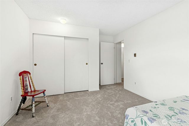 a view of a bedroom with bed and furniture