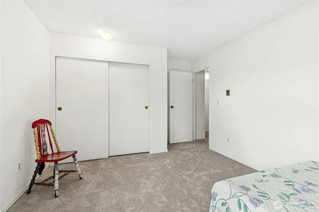 a view of a bedroom with bed and furniture