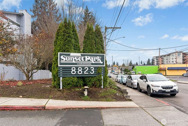 a view of a street with cars parked