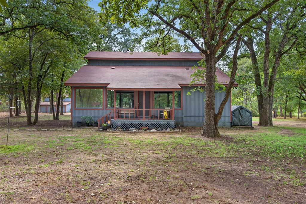 10964 River Ranch Road Kemp, TX 75143 - Photo 1 of 40 Wooded lot with mature trees, a covered porch, and a utility shed