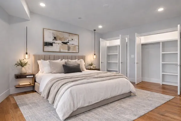 a bedroom with bed and wooden floor
