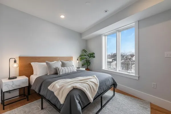 a bedroom with a large bed and a window
