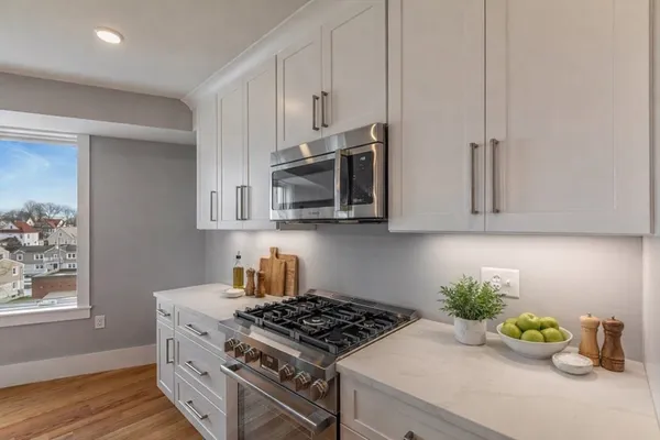 a kitchen with stainless steel appliances a stove a microwave and cabinets