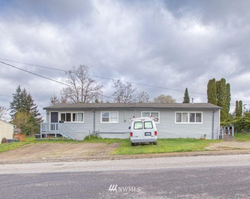 2818 Northeast 6th Place Renton, WA 98056 - Photo 1 of 11 a front view of a house with a yard and potted plants